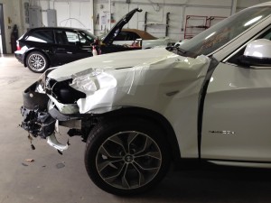 New car loses fight with chain link fence.