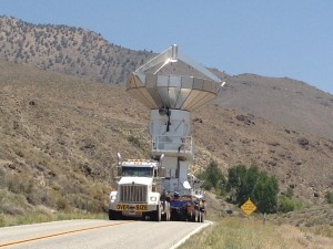 Small road, big load.  Someone is moving satellite equipment and I can only pull off road and watch,